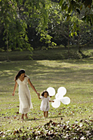 Mother and daughter in park, with balloons - Alex Mares-Manton
