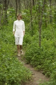 young woman walking in woods - Alex Mares-Manton