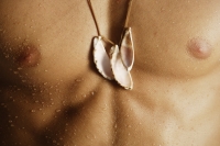 torso of man wearing shell necklace - Alex Mares-Manton