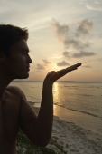 profile of man holding sunburst - Alex Mares-Manton