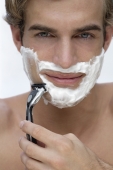 young man shaving face - Alex Mares-Manton