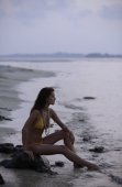 Profile of woman sitting on beach - Alex Mares-Manton