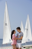 couple embracing near sailboats - Alex Mares-Manton