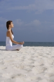woman doing yoga on the beach - Alex Mares-Manton