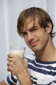 portrait of young man with glass of milk - Alex Mares-Manton