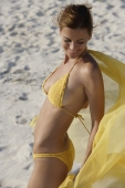 woman in yellow bikini wrapped in yellow fabric - Alex Mares-Manton