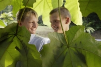 young boys behind giant leaves - Alex Mares-Manton