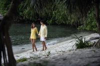 young couple walking on beach - Alex Mares-Manton