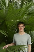 young man standing in tropical plants - Alex Mares-Manton