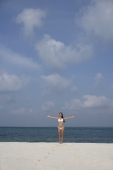 young woman in white bikini on beach - Nugene Chiang