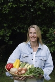 woman holding basket of vegetables - Alex Mares-Manton