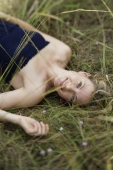 young woman lying in field - Alex Mares-Manton