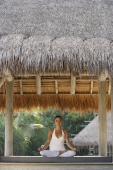 woman doing yoga in tropical sala - Alex Mares-Manton