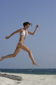 woman in white bikini running and jumping - Alex Mares-Manton
