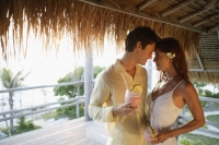 young couple with tropical drinks - Alex Mares-Manton