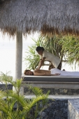 woman receiving massage in tropical sala - Alex Mares-Manton