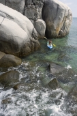 man kayaking near rocks - Alex Mares-Manton