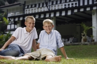 two boys sitting on grass - Alex Mares-Manton