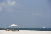 two lounge chairs on white sand beach - Alex Mares-Manton