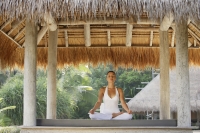 woman doing yoga in tropical sala - Alex Mares-Manton