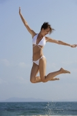 Woman in white bikini, jumping in air - Alex Mares-Manton