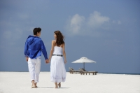 couple holding hands on beach - Alex Mares-Manton