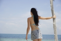back of woman looking at beach - Nugene Chiang