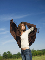 Young woman wrapping herself in brown shawl - Alex Hajdu