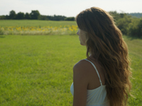Profile of young woman in meadow - Alex Hajdu