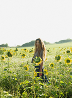 Young woman in field of sunflowers - Alex Hajdu