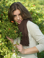 Young woman holding branch of berry bush - Alex Hajdu
