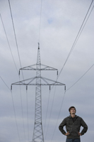 Young man standing under power line - Alex Mares-Manton