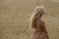 Profile of young woman standing in field - Alex Mares-Manton