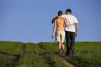 Young couple walking up hillside - Alex Mares-Manton