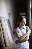 woman standing in hallway full of paintings - Alex Mares-Manton