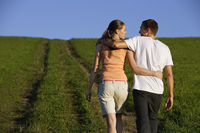 Young couple taking walk up hillside - Alex Mares-Manton