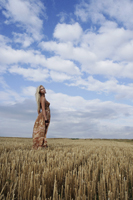 Young woman standing in field - Alex Mares-Manton