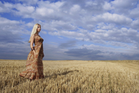 Young woman standing in field - Alex Mares-Manton