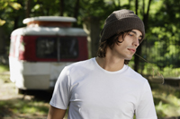 Young man standing in front of camper - Alex Mares-Manton