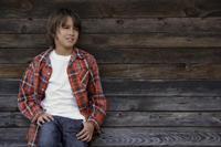 boy leaning against barn wall - Alex Mares-Manton