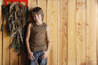 boy leaning against stable wall - Alex Mares-Manton