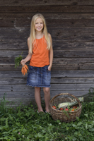 girl holding bunch of carrots - Alex Mares-Manton