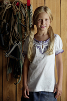 girl standing in horse barn - Alex Mares-Manton