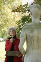 Senior woman pondering statue - Alex Mares-Manton