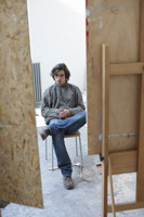 man sitting in studio - Dennison Bertrand