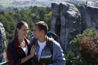 Young couple standing on mountain top - Alex Mares-Manton
