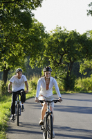 Young couple riding bicycles - Alex Mares-Manton