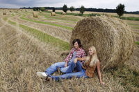 young couple leaning against haystack - Alex Mares-Manton