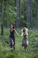 Young women running through forest - Alex Mares-Manton