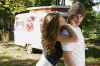 Young couple in front of camper - Alex Mares-Manton